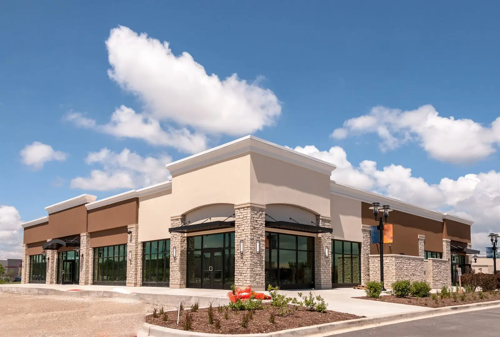 Completed commercial retail and office building under a blue sky