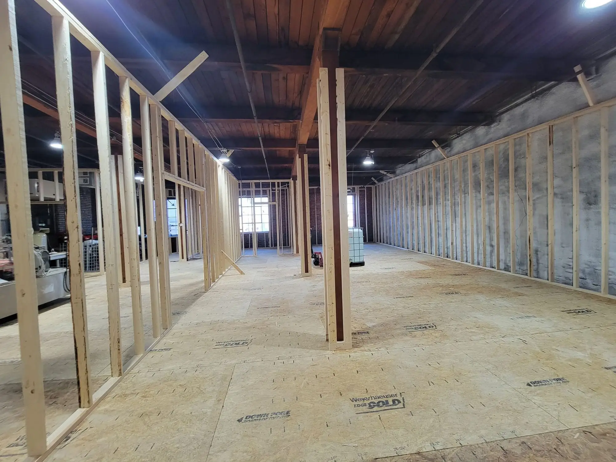Timber stud partitions framed out across a commercial floor under an exposed timber ceiling